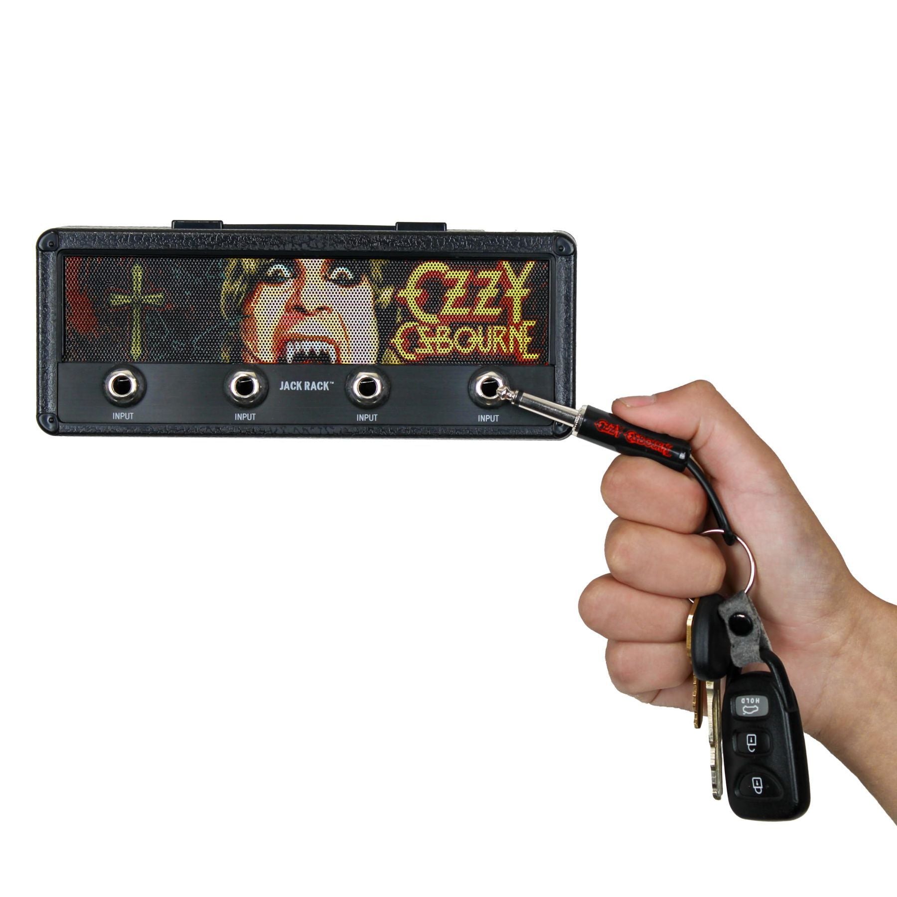 P Pluginz Ozzy Osbourne Jack Rack key hanger — hand inserting a guitar-plug keychain into the rack — Slide 4 of 9
