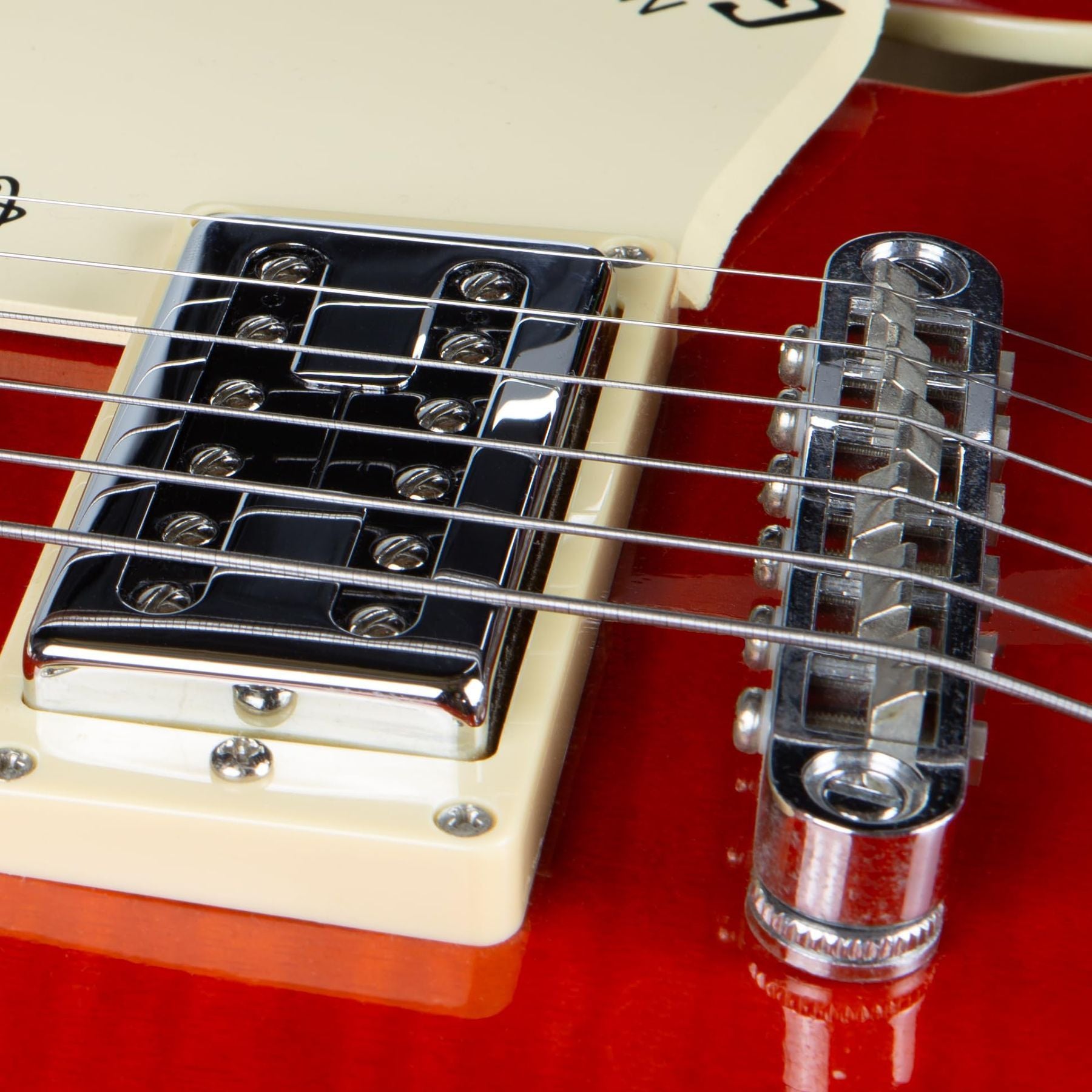 GHS Precision Flatwound 800 extra-light electric guitar strings — close-up of the strings installed at a guitar bridge — Slide 6 of 9