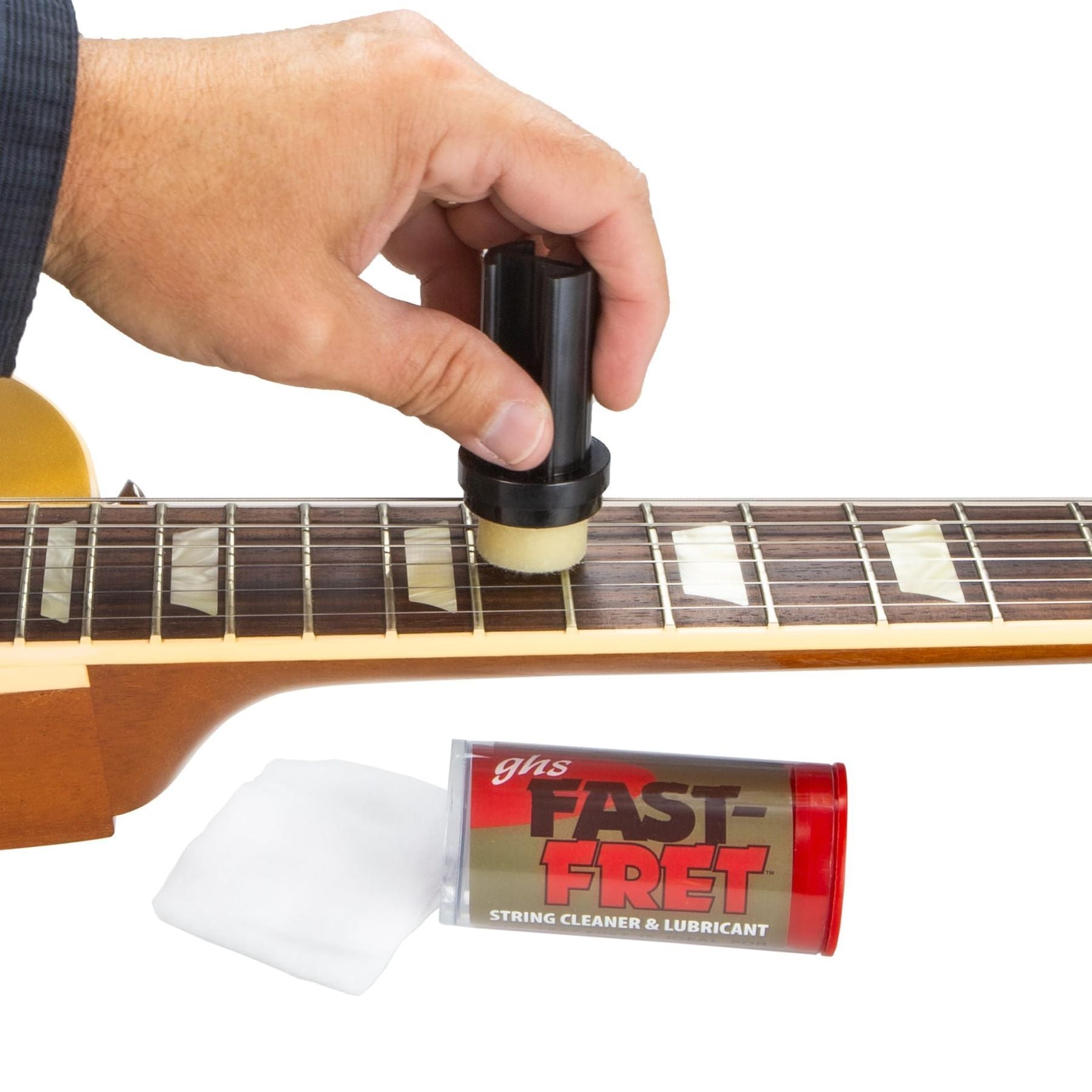 GHS Fast Fret string cleaner and lubricant — hand applying cleaner to acoustic guitar strings, with cloth and container — Slide 9 of 9