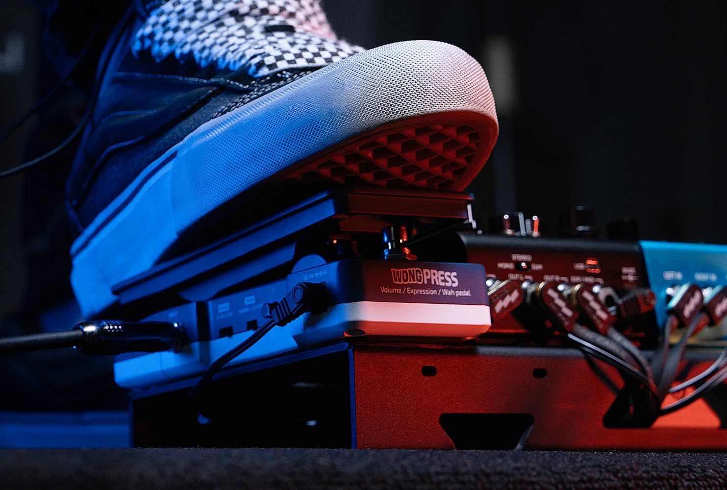 Hotone SP-21 Wong Press volume, expression and wah pedal — musician operating the pedal on a connected pedalboard — Slide 9 of 9