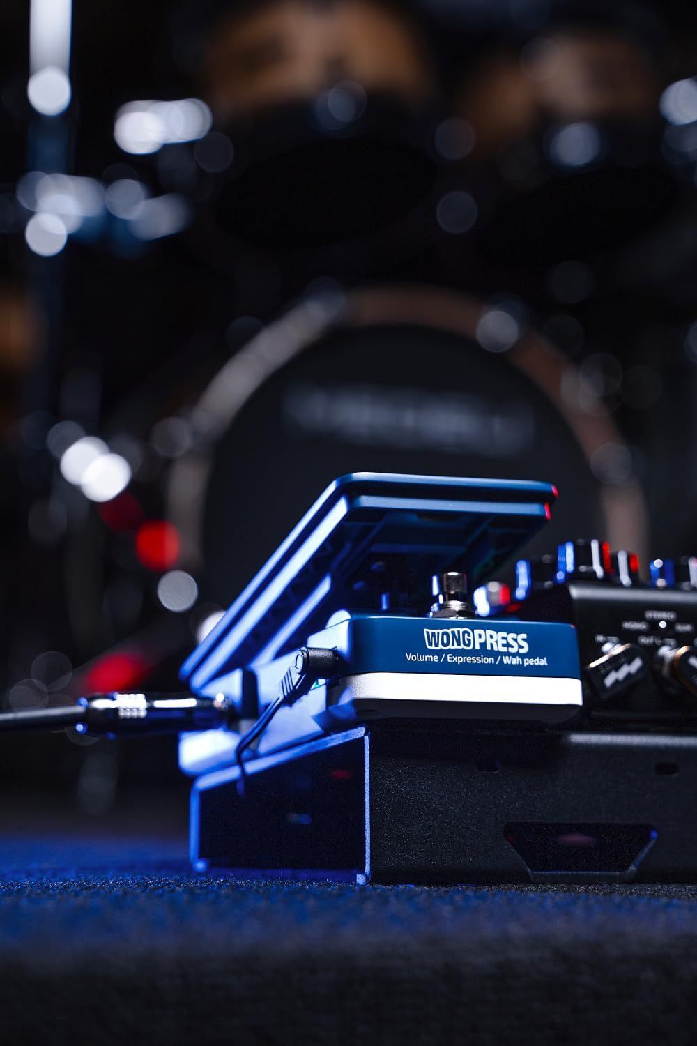 Hotone SP-21 Wong Press volume, expression and wah pedal — connected on a stage pedalboard under blue lighting — Slide 8 of 9