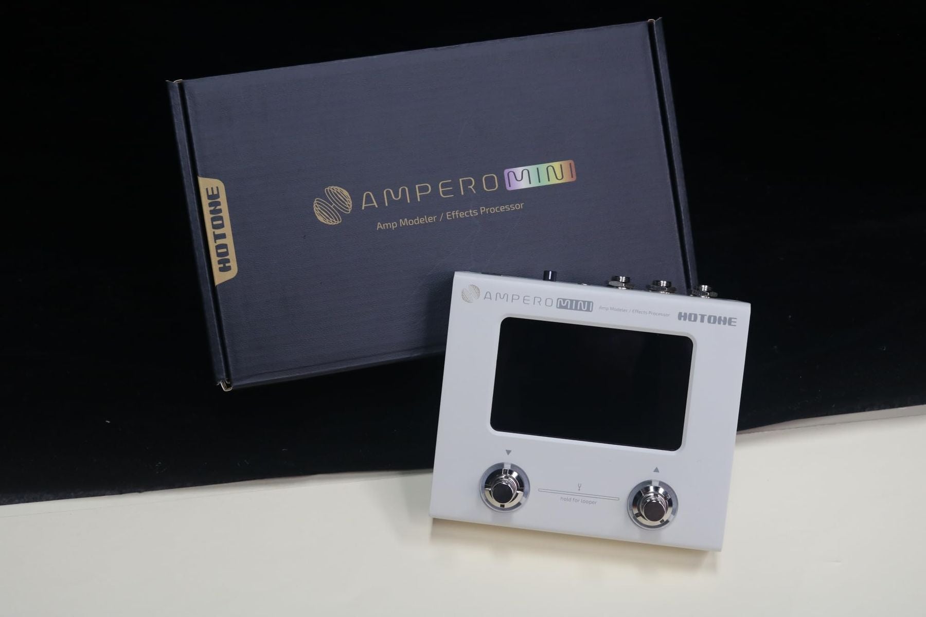 Hotone Ampero Mini MP50VN effects processor — front view displayed with the retail box — Slide 3 of 9