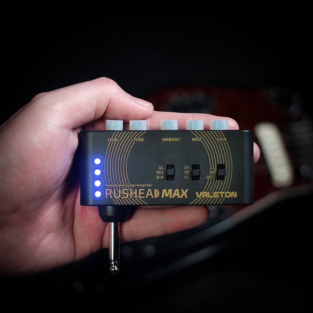 Valeton Rushead Max pocket guitar headphone amplifier — amplifier held in one hand to show its compact size — Slide 7 of 7