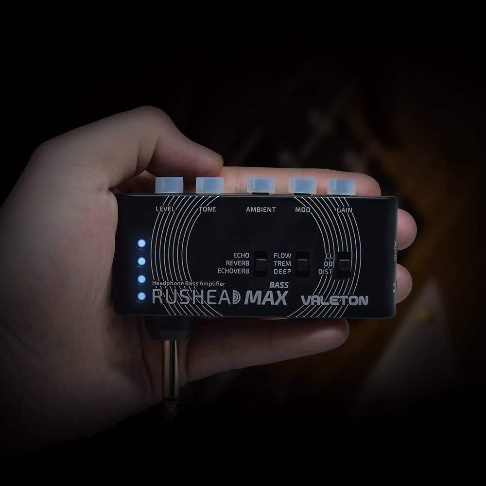 Valeton Rushead Max Bass pocket headphone amplifier — amplifier held in one hand to show its compact size — Slide 7 of 7